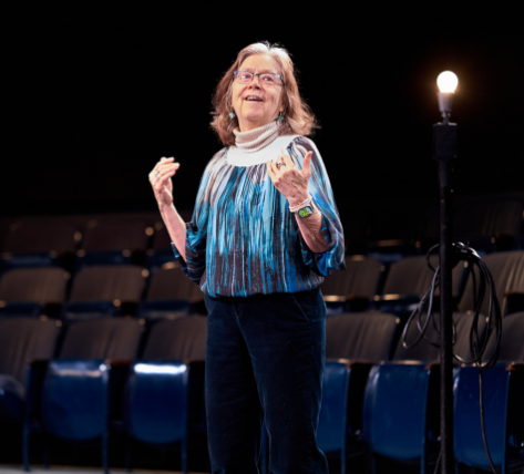 a lady teaching on stage