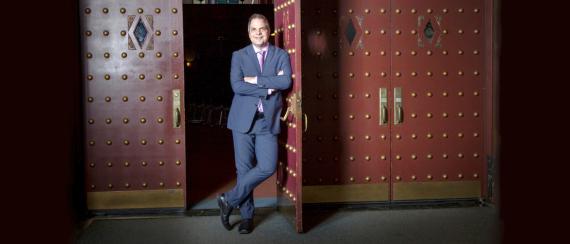David Armstrong stands at the front doors of the 5th Avenue Theater.