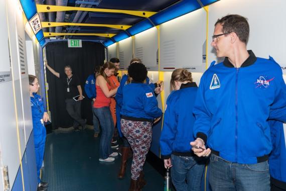 Magelssen (R) and crew mates suit up at the Museum of Flight’s Challenger Learning Center.