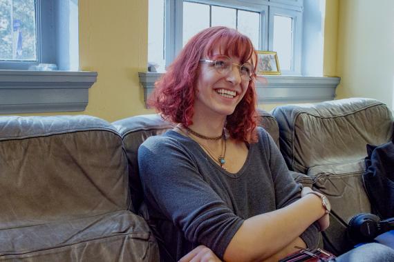 Rosemary sitting on couch with crossed arms.