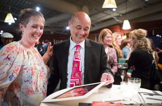 Ruben Van Kempen, with a former student, at a party celebrating his retirement and raising funds to support the Roosevelt High Drama program. (Lindsey Wasson / The Seattle Times)