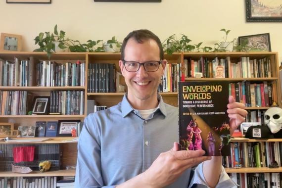 Scott Magelssen holding a book