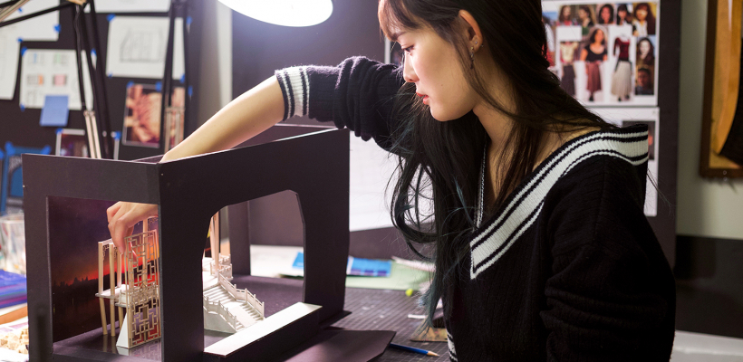 Shin-yi Lin (MFA, scenic design, 2019) at her desk in the graduate design studio | Photo by Kyler Martin