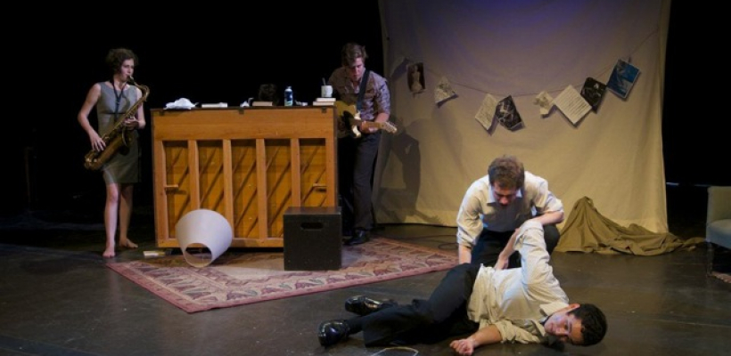 One man lays on the ground near the chalk outline while another sits behind him. A saxaphonist, guitarist, and pianist are playing in the background.