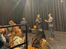 two men standing and clapping