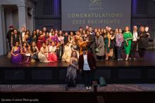 A group of Gregory Awards nominees and winners standing and smiling on stage at Town Hall Seattle following the 2025 ceremony.