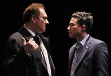 Two men in suits talking to each other.