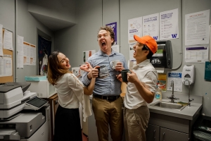 Three people laughing an office 