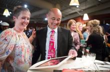 Ruben Van Kempen, with a former student, at a party celebrating his retirement and raising funds to support the Roosevelt High Drama program. (Lindsey Wasson / The Seattle Times)