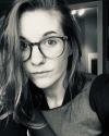 A white woman with glasses and blonde hair