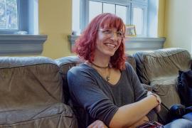 Rosemary sitting on couch with crossed arms.
