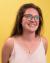 Haley smiles in front of a sunny yellow-colored backdrop.