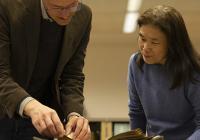 Scott Magelssen and Julie Tanaka look at an illustrated Shakespeare book donated to UW Libraries. 
