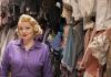 Portrait of Chante Hamann, standing in one of the School of Drama's storage rooms for costumes.