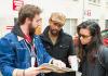 Nathan Wornian, AJ Friday, and Hazel Lozano discuss logistics for performing their theater piece in a U-District alley.