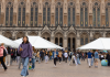 Students walk through Red Square near white tents.