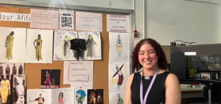 Picture of Nour in front of her artwork