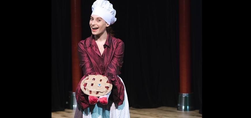 Daphne Sage Gonzales holds a pie designed by Props Master Kayleah Lewis for UTS' Complete Works of William Shakespeare (Abridged)