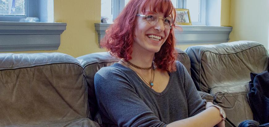 Rosemary sitting on couch with crossed arms.
