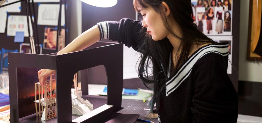 Shin-yi Lin (MFA, scenic design, 2019) at her desk in the graduate design studio | Photo by Kyler Martin