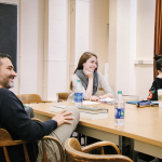 Drama Ph.D. students laugh during a seminar class