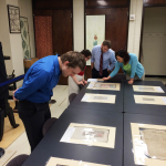 Drama PhD students look at medieval manuscripts in Special Collections.