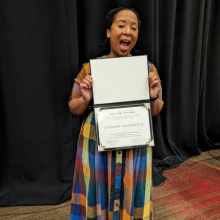 Jasmine holding award