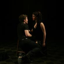 MacHeath shares a romantic moment with one of his three women, Lucy.