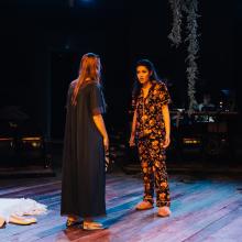 Two women in pajamas confront each other