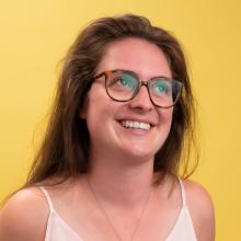 Haley smiles in front of a sunny yellow-colored backdrop.