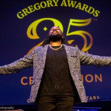 Opening Performer on Stage – A performer opens the 25th Annual Gregory Awards celebration